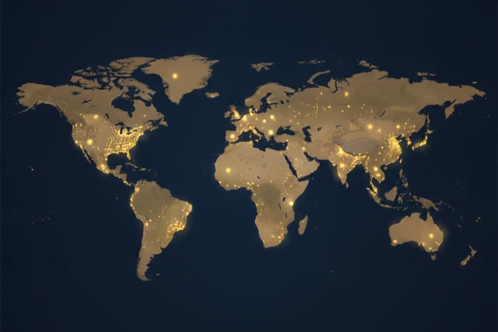 A flat world map at night with city lights glowing across every continent